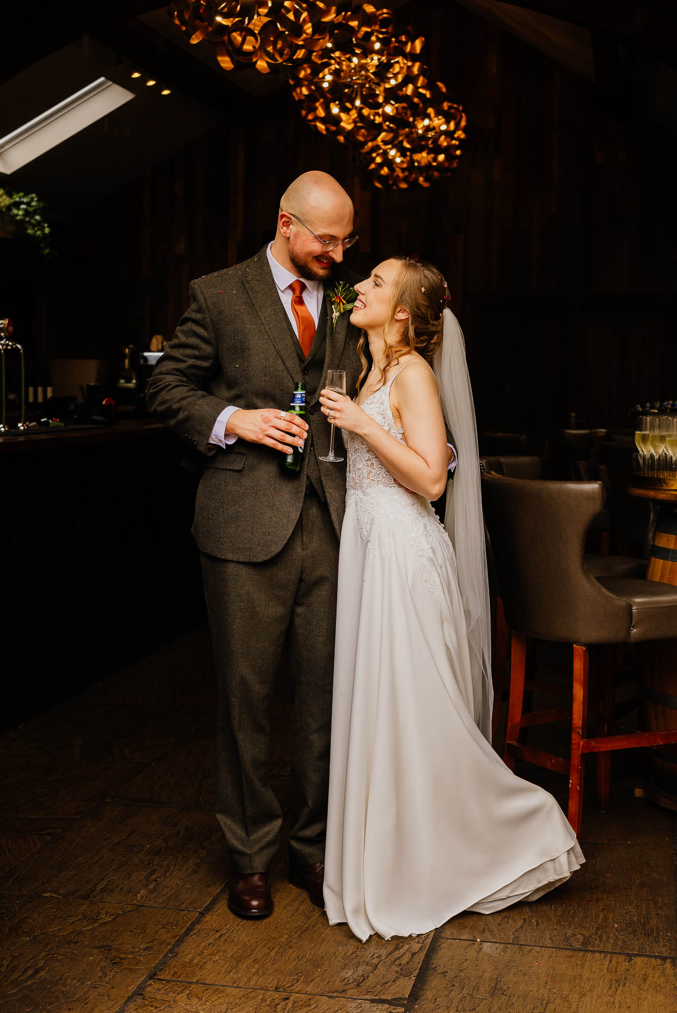 Couple sharing drinks in the orangery bar at The Woodman Inn