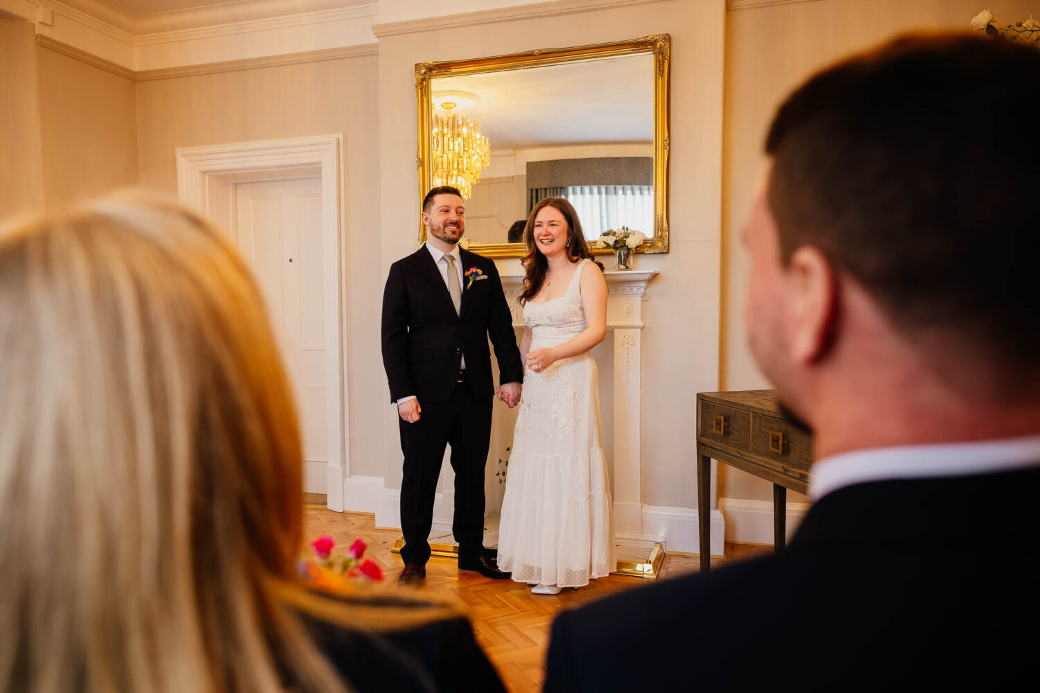 Couple holding hands in Byron room at Harrogate Register Office