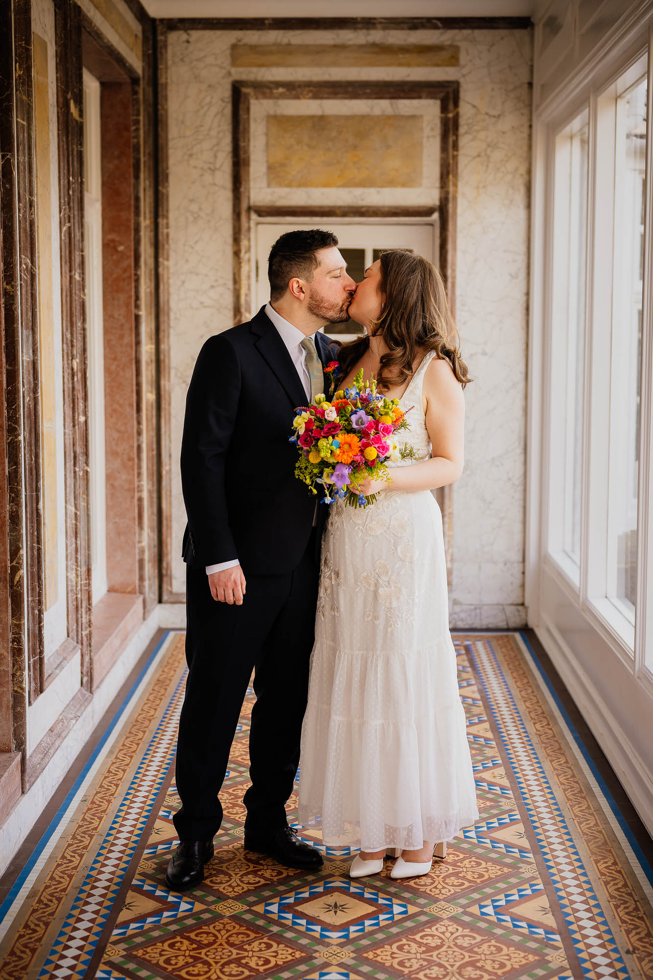 Couple kiss in the tiled hallway at Harrogate Register Office