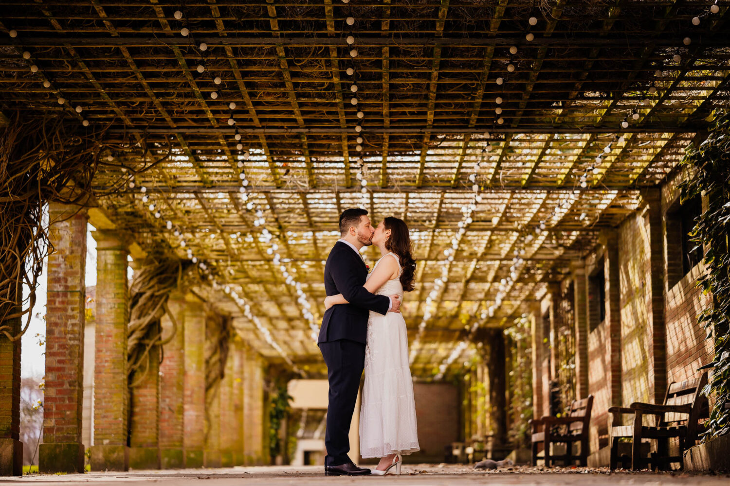 Couple kiss under walkway in Harrogate Valley Gardens