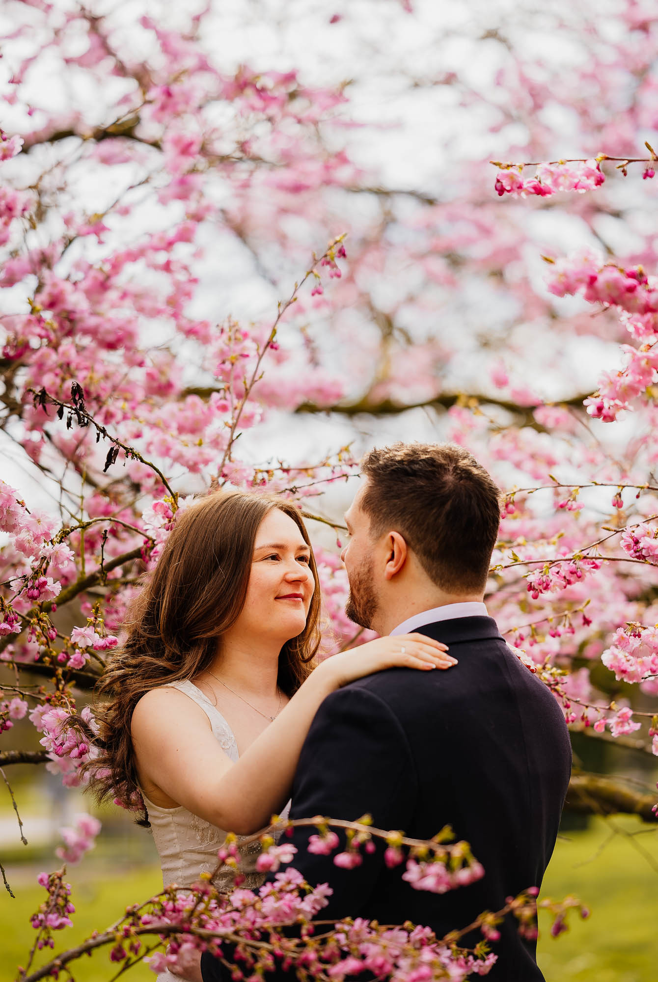 Couple surrounded by blossom in Harrogate Valley Gardens