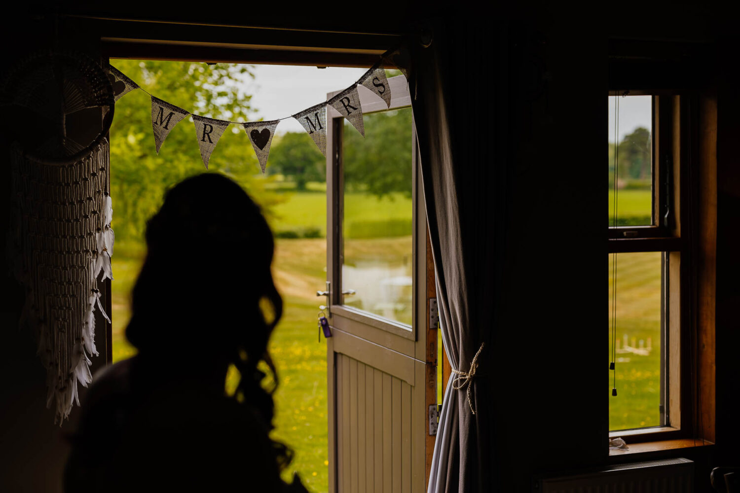 Bride silhouette in doorway of The Stables