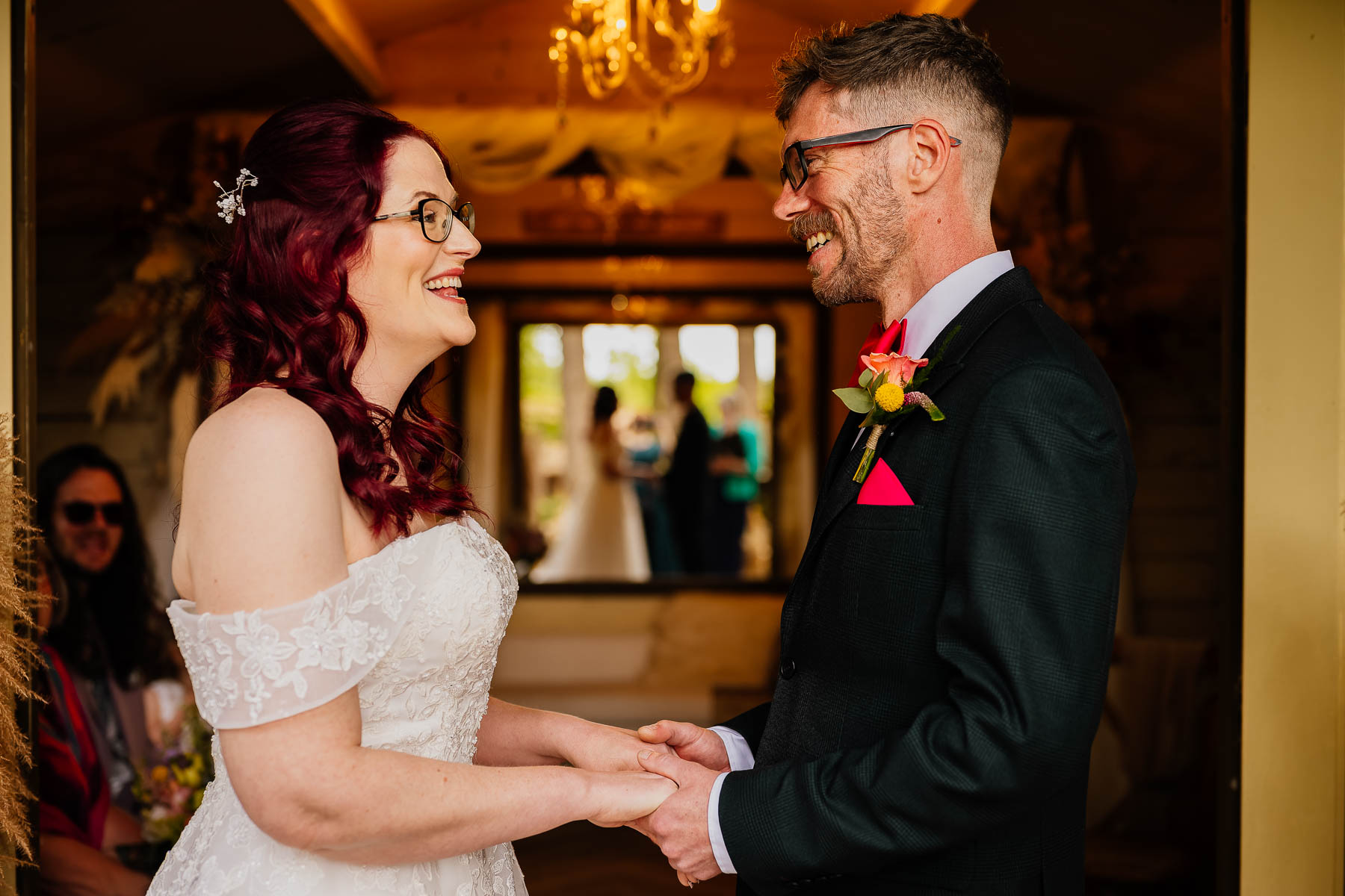Bride and groom holding hands and laughing in The Love Shack