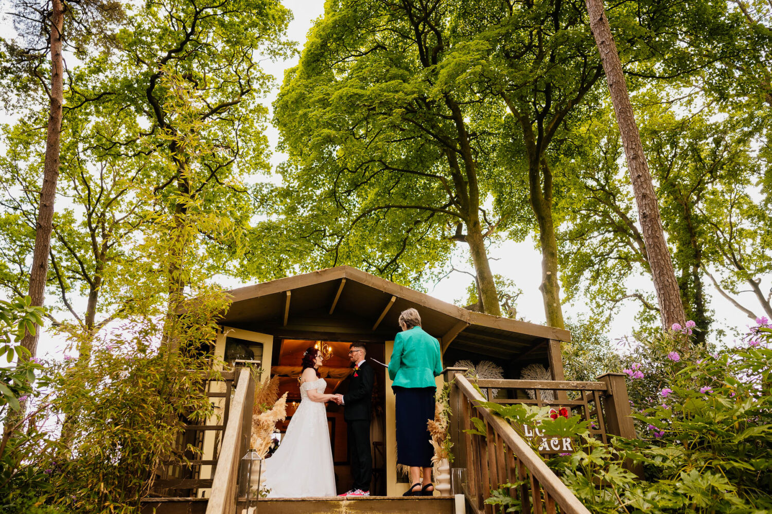 Ceremony at The Love Shack with trees in the background