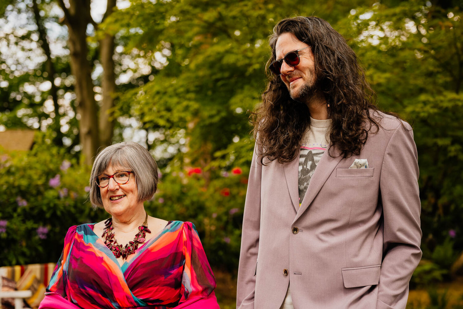 Wedding guests smiling in woodland