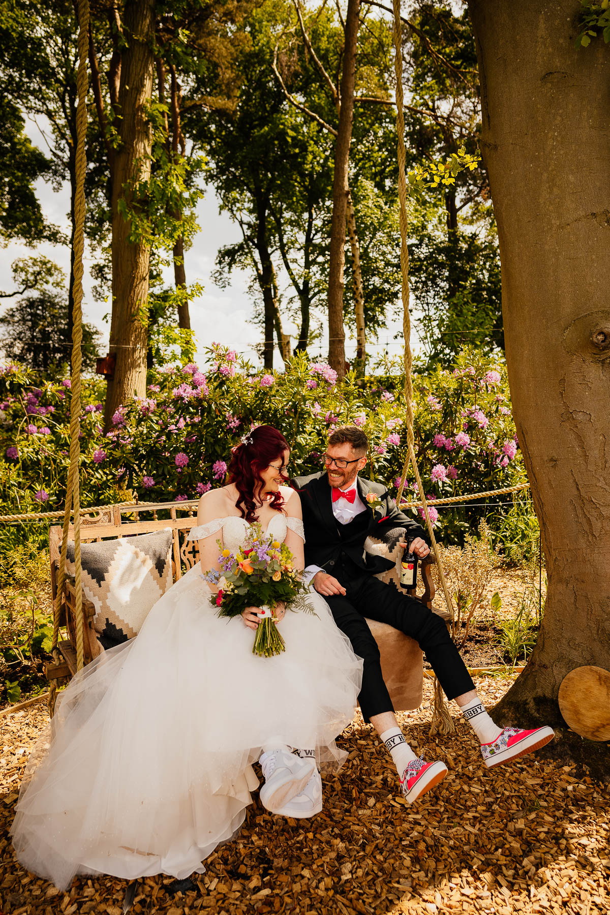 Bride and groom sat on tree swing at The Love Shack