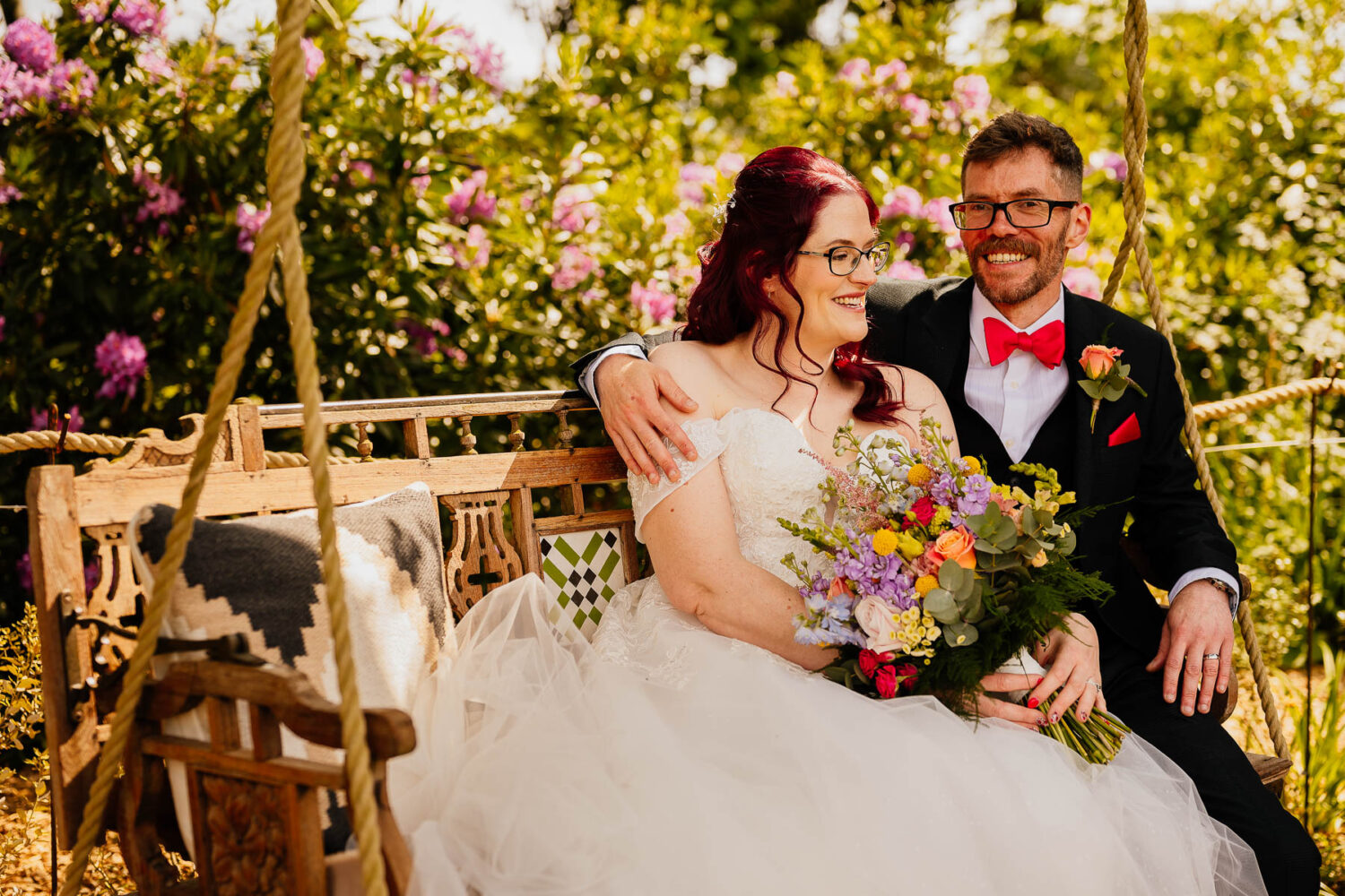 Bride and groom on a swing bench