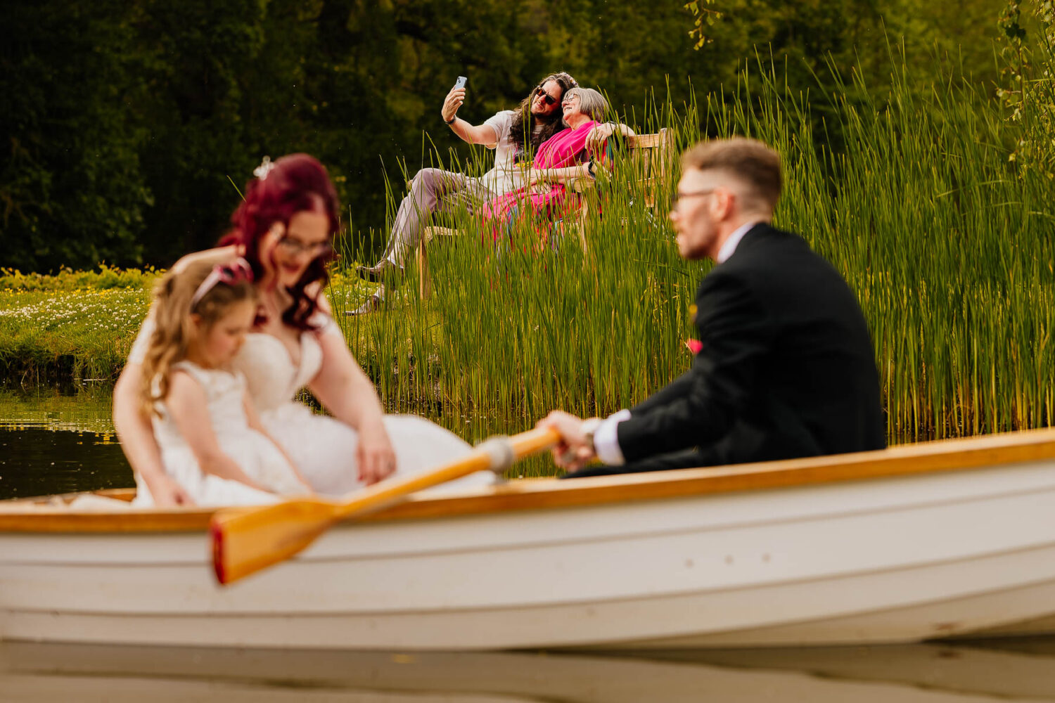 Family taking a selfie with rowboat in the foreground