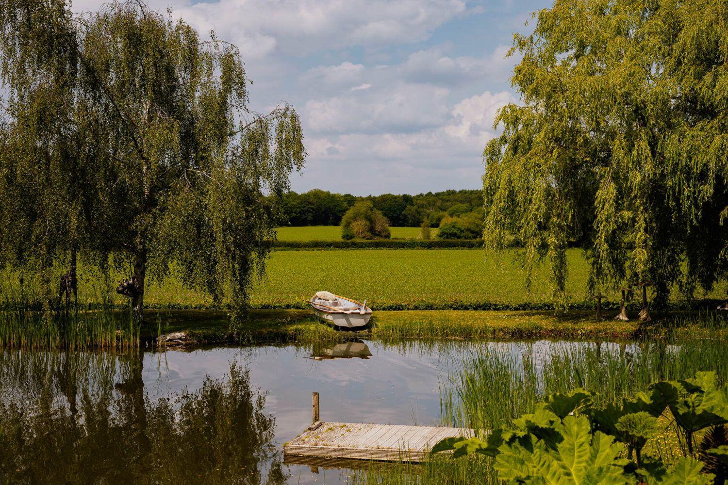 The lake at The Love Shack with rowing boat on the shore