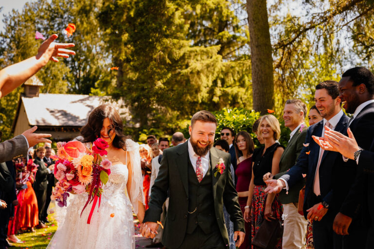 Couple walking through guests at Hackness Grange
