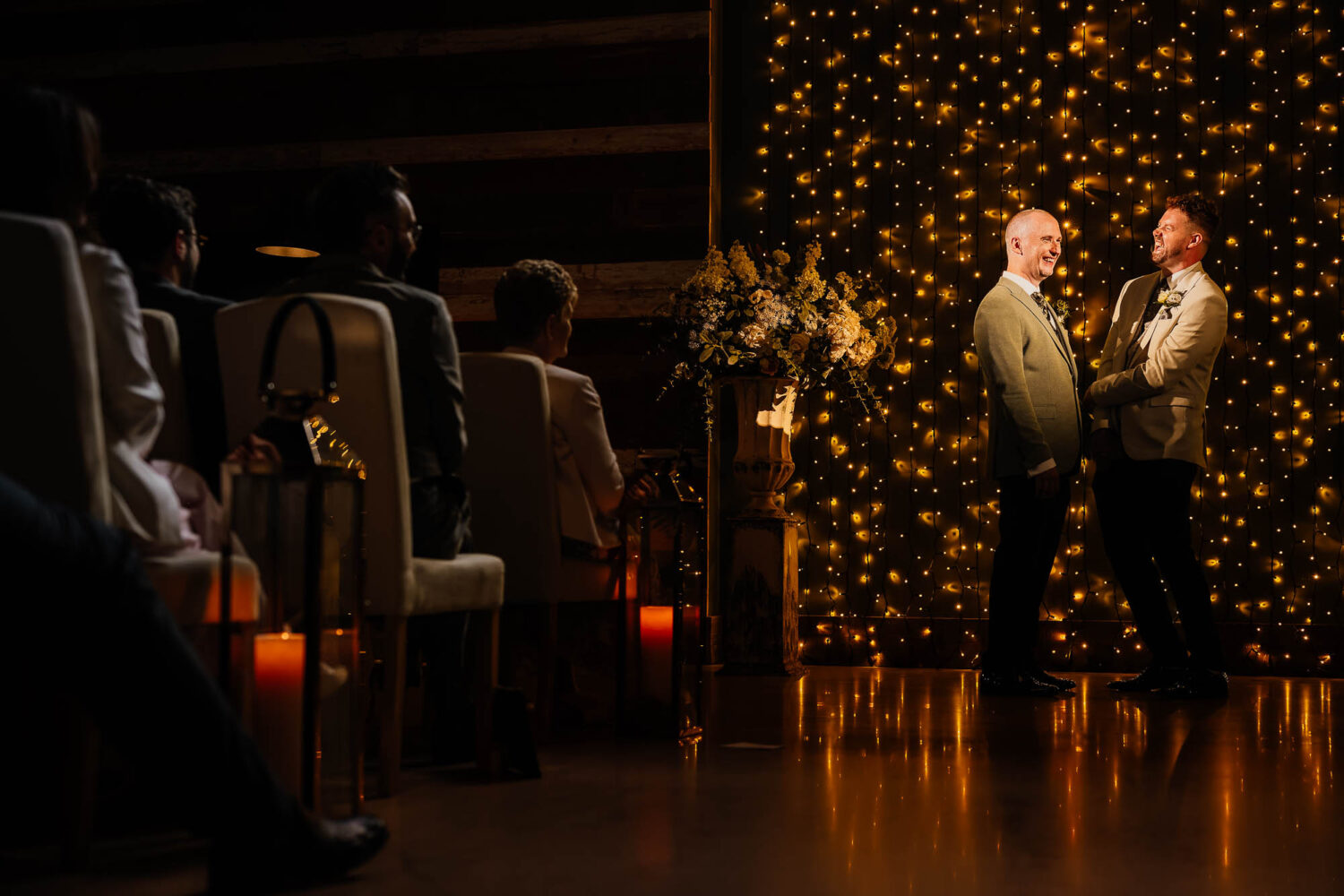 Grooms stood in front of fairylights during Wharfedale Grange ceremony