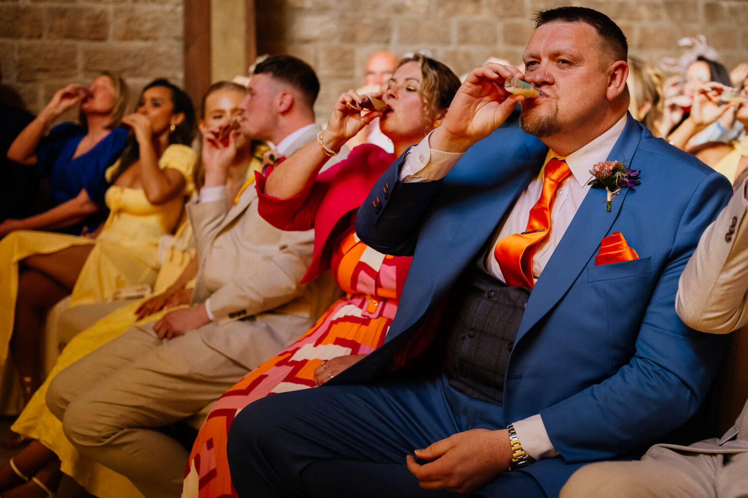 Wedding guests drinking shots during Wharfedale Grange ceremony