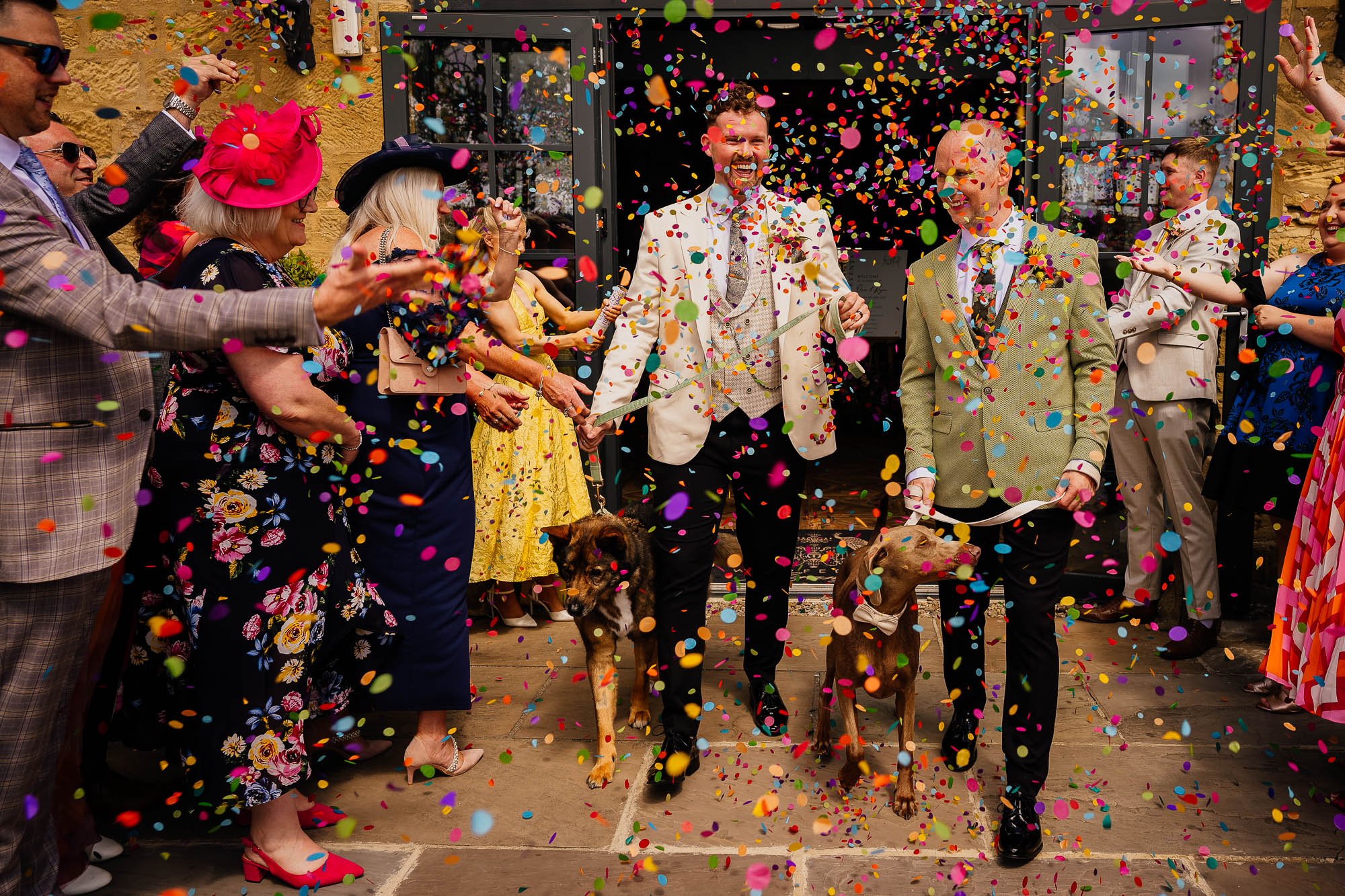 Colourful confetti at Wharfedale Grange with two grooms and two dogs