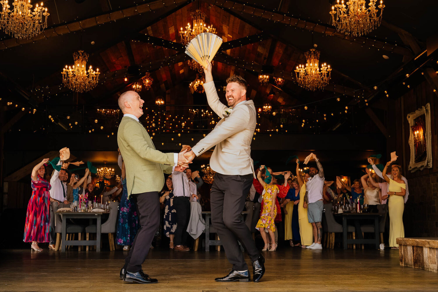 Grooms dancing during entrance to wedding breakfast at Wharfedale Grange