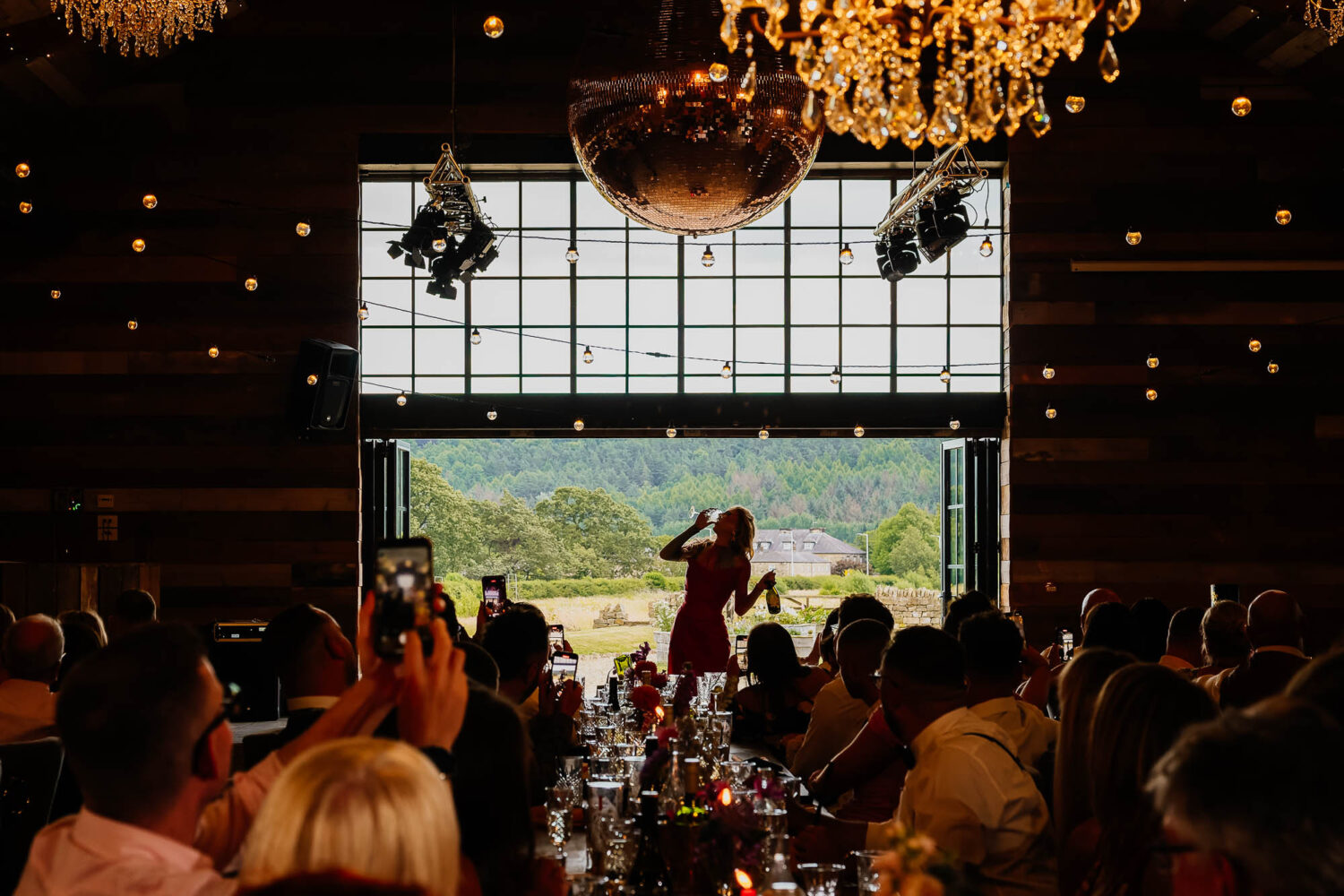 Guests watching at drag queen enters Wharfedale Grange through barn doors