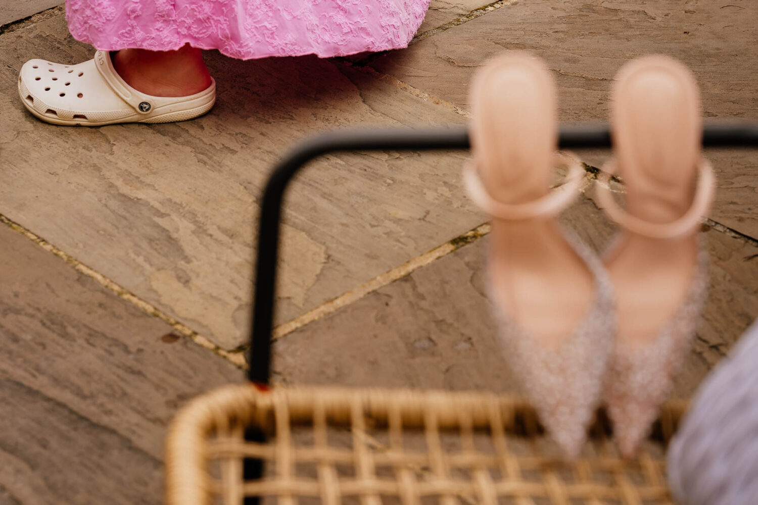 Guest wearing crocs with heels hooked on a chair