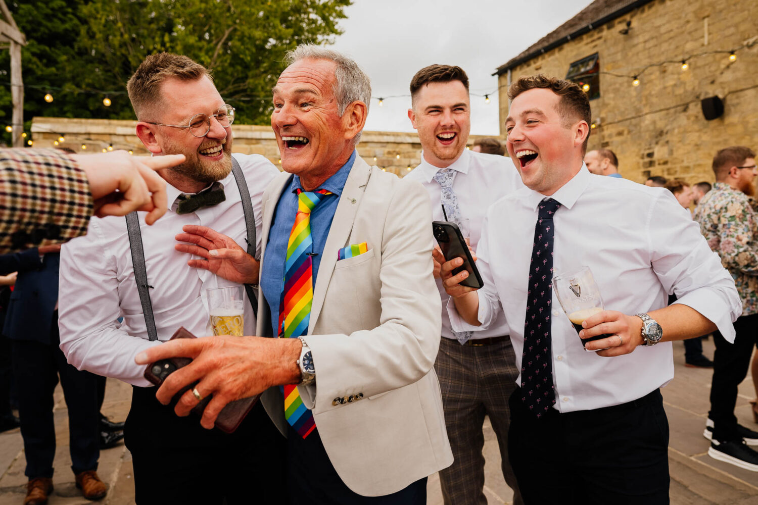Four wedding guests laughing during Wharfedale Grange wedding reception