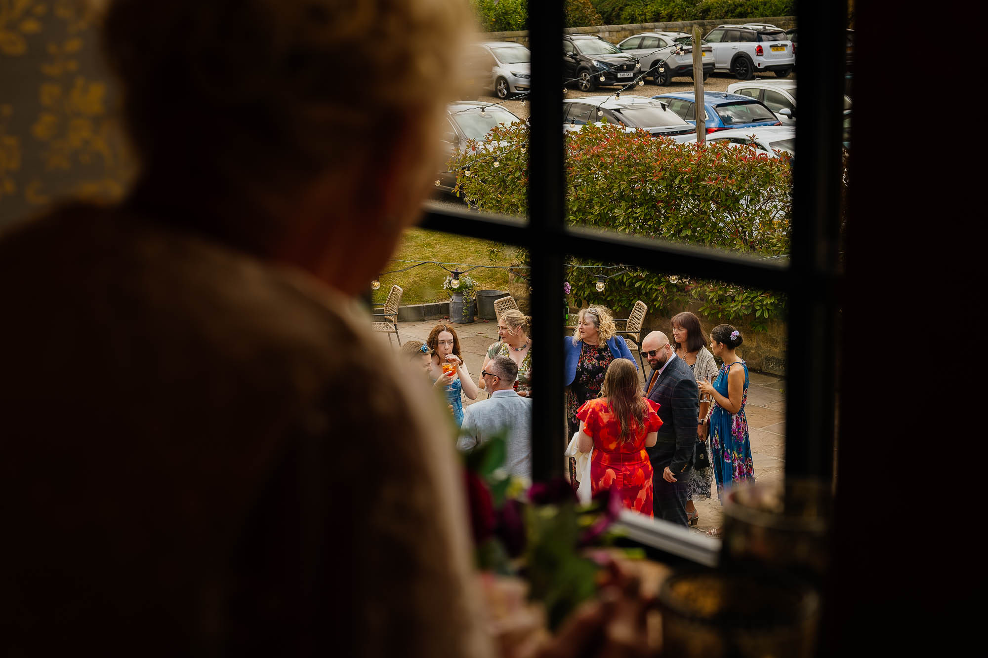 Woman looking out over guests arriving at Wharfedale Grange