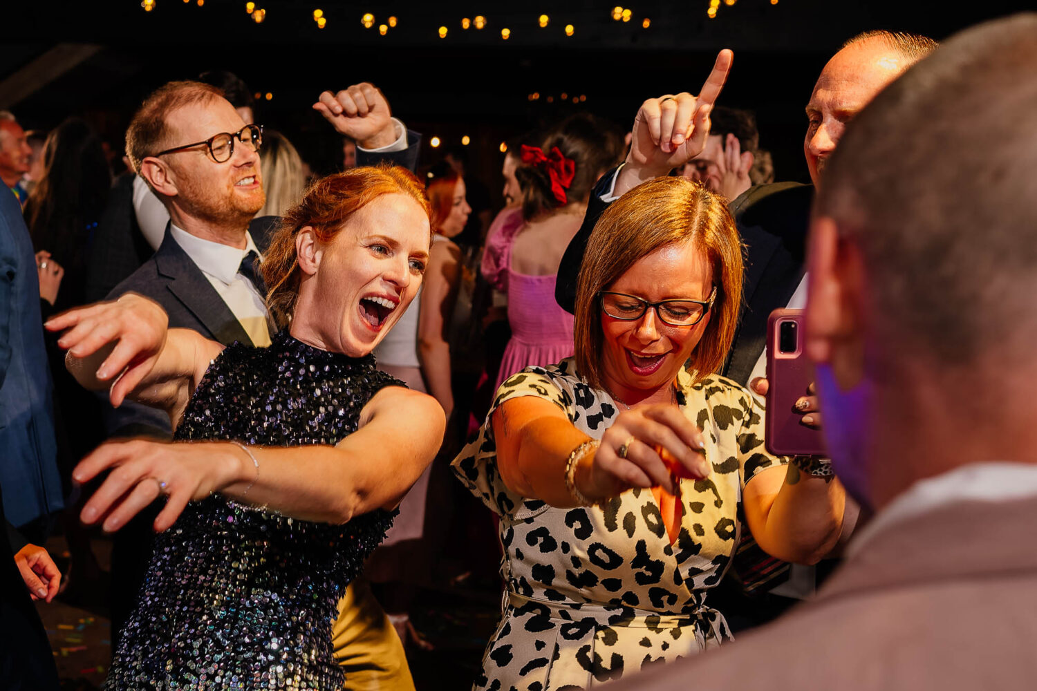 Guests with arms out on the dancefloor