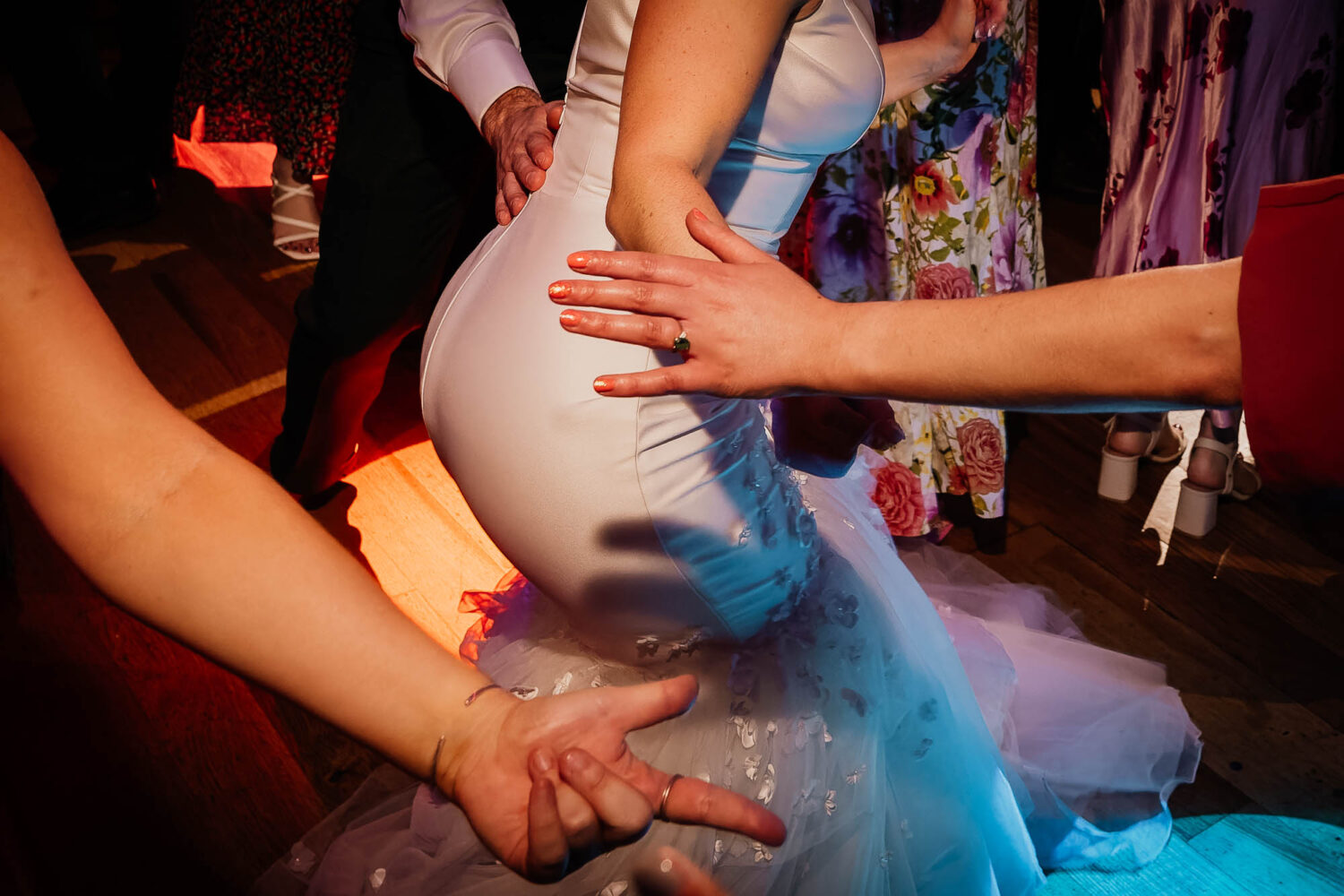 Bride dancing with hands reaching out for her