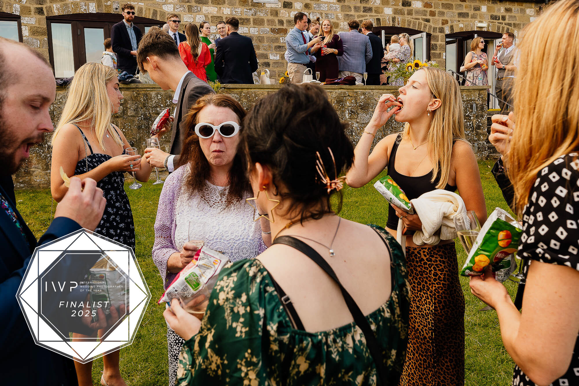A finalist image in the IWPOTY awards of people eating crisps at a wedding