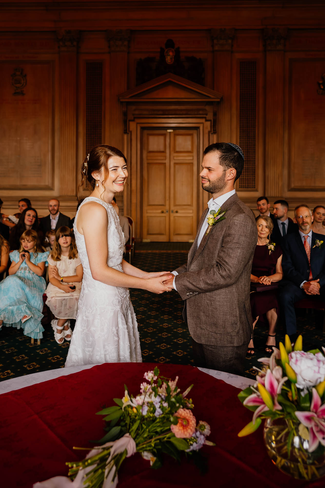 Couple holding hands in the Banquet Hall at Leeds Civic Hall