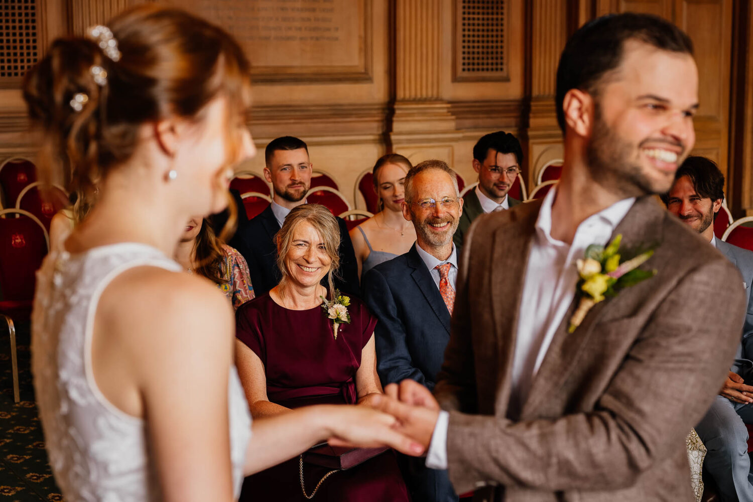 Parents smiling during ring exchange at Leeds Civic Hall wedding