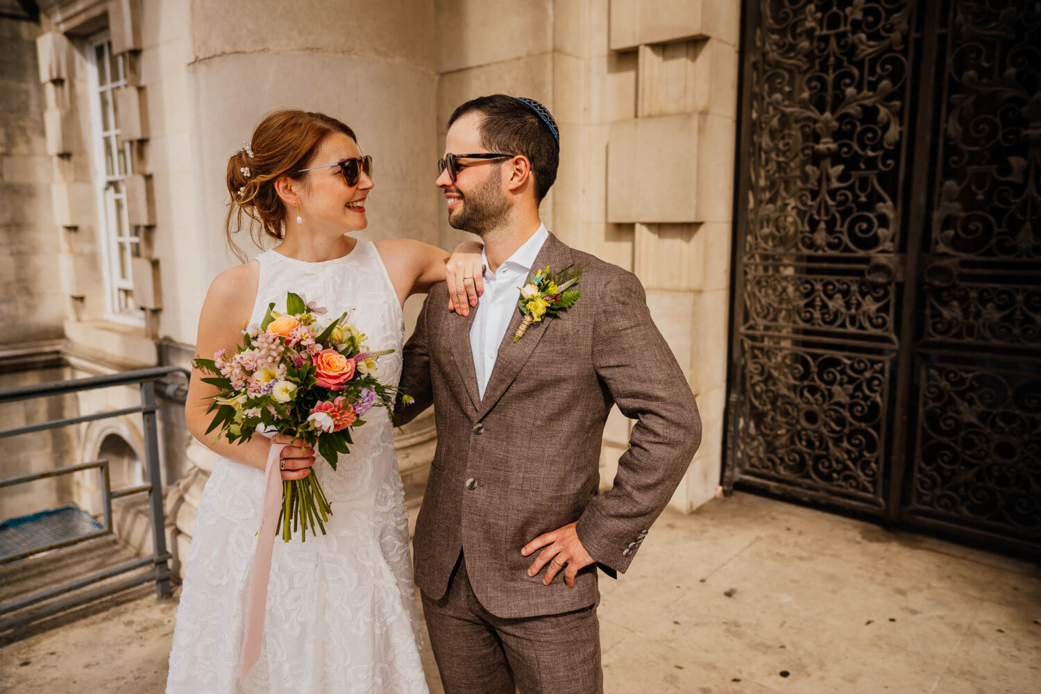Couple outside Leeds Civic Hall in sunglasses