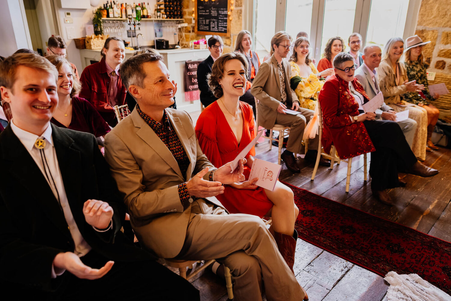 Wedding guests laughing during ceremony