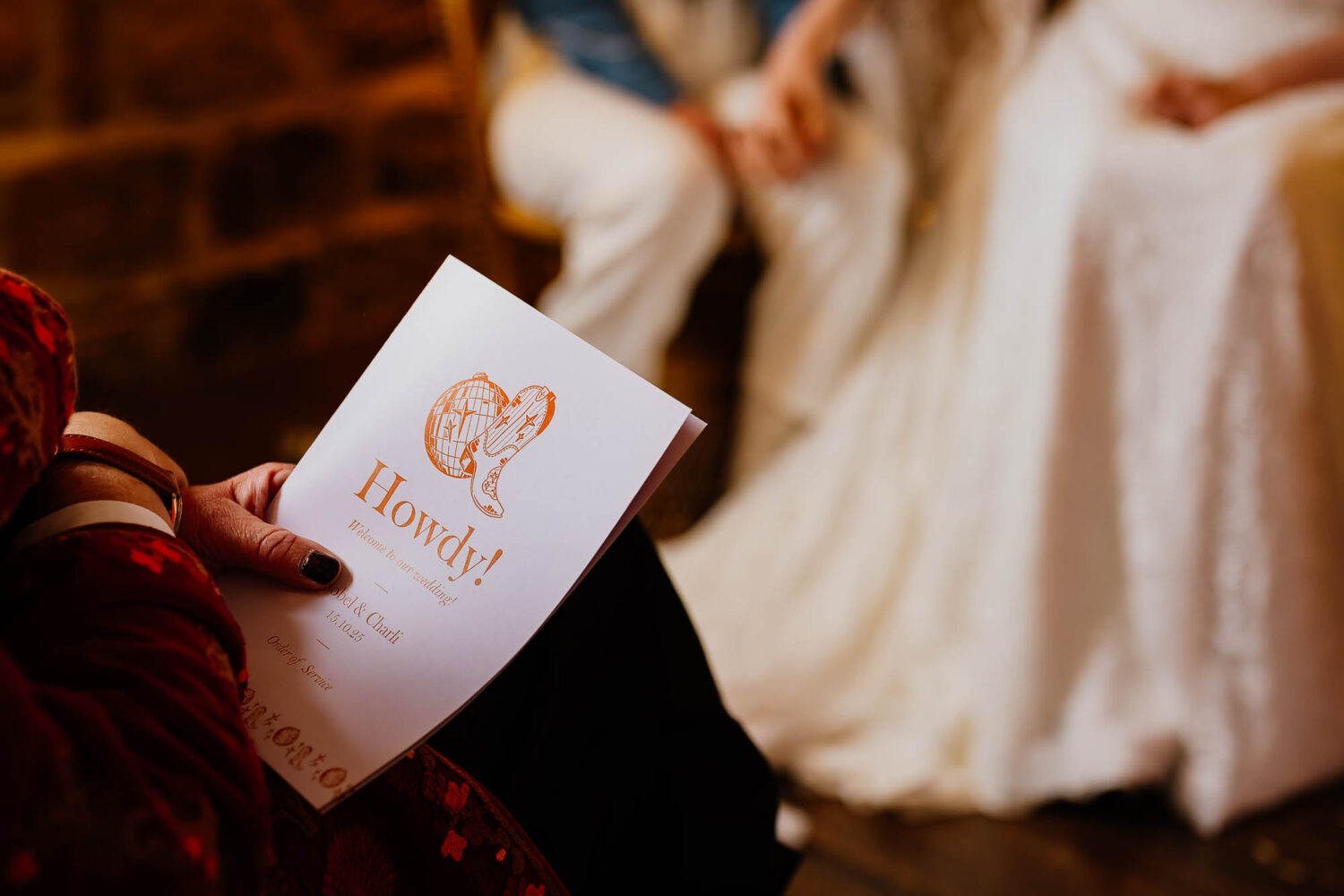 Close up of order of service with disco ball and cowboy boot on