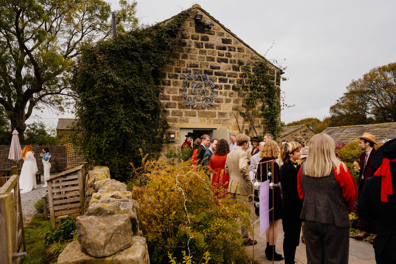 Couple waiting outside Chilli Barn whilst guests queue for confetti