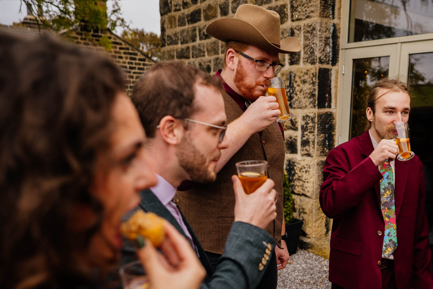 Four people eating and drinking during wedding reception
