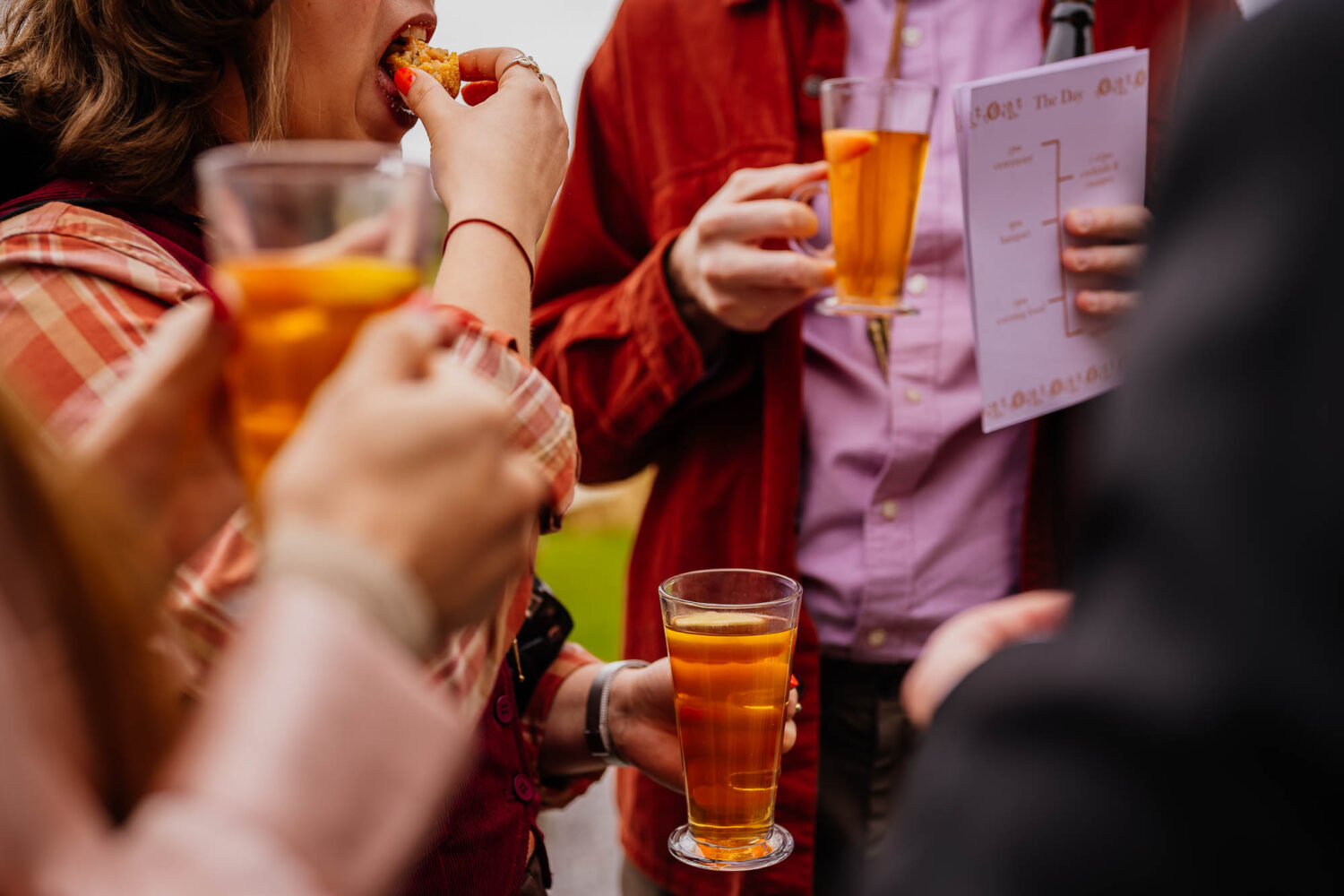 Guests holding warm cider and eating canapes