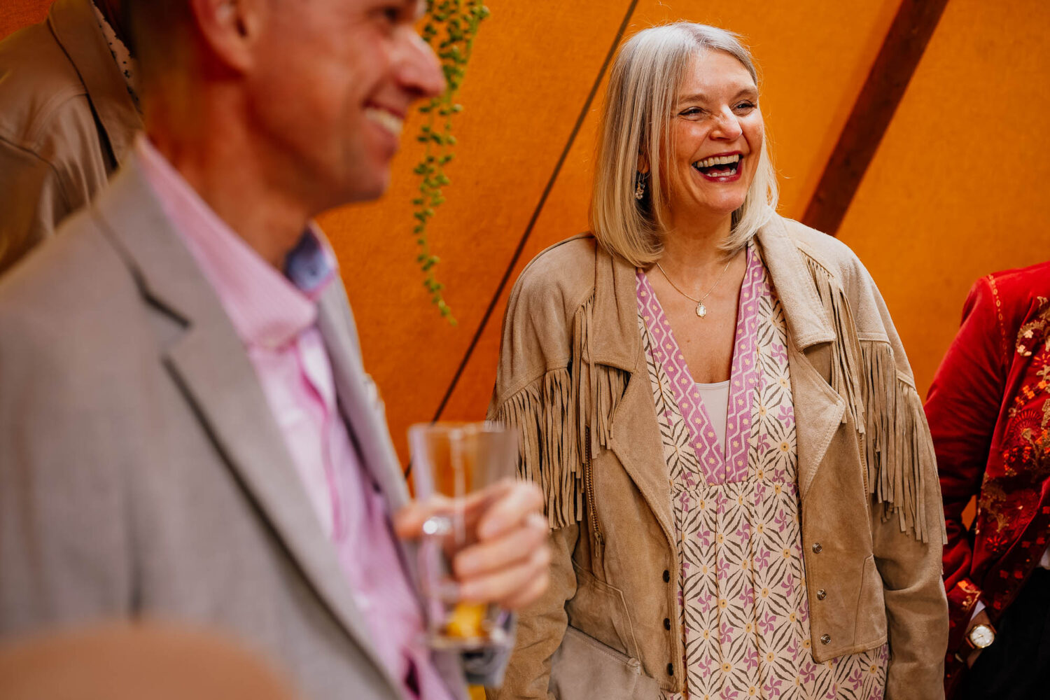 Guests laughing in wedding tipi