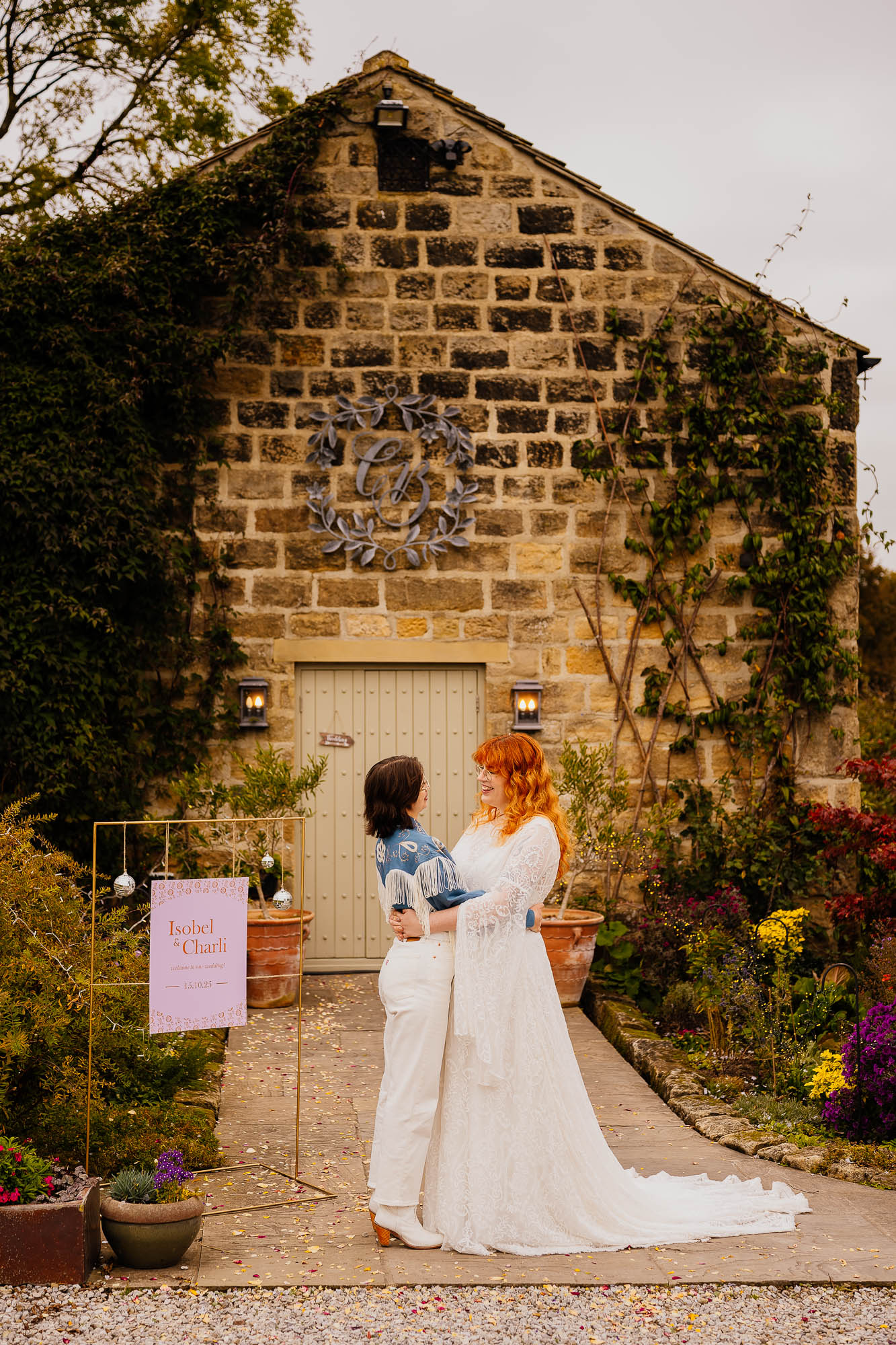 Couple outside Chilli Barn with disco ball sign next to them