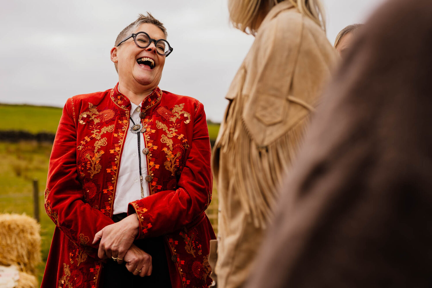 Wedding guest laughing during drinks reception