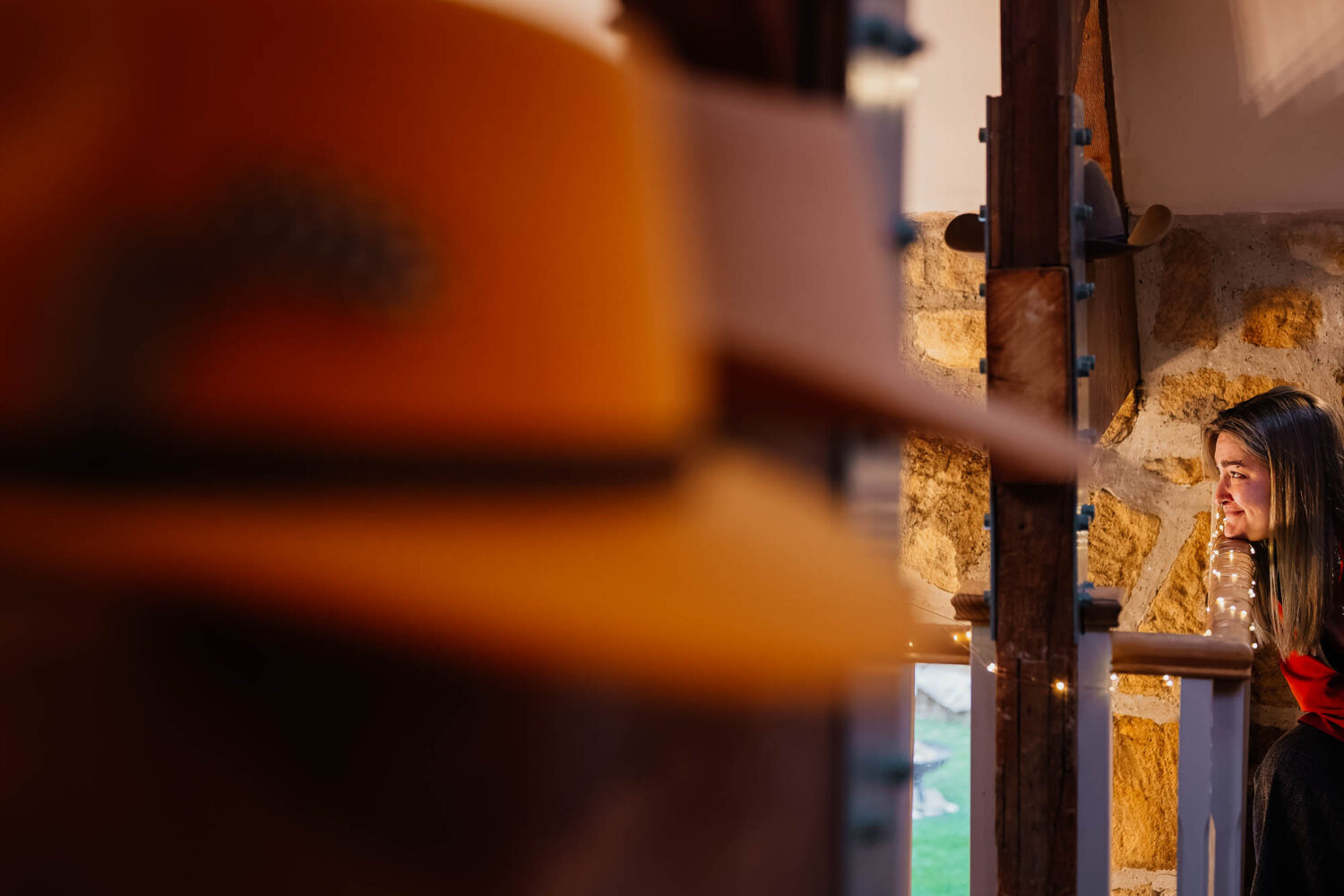 Guest resting head on bannister with cowboy hats