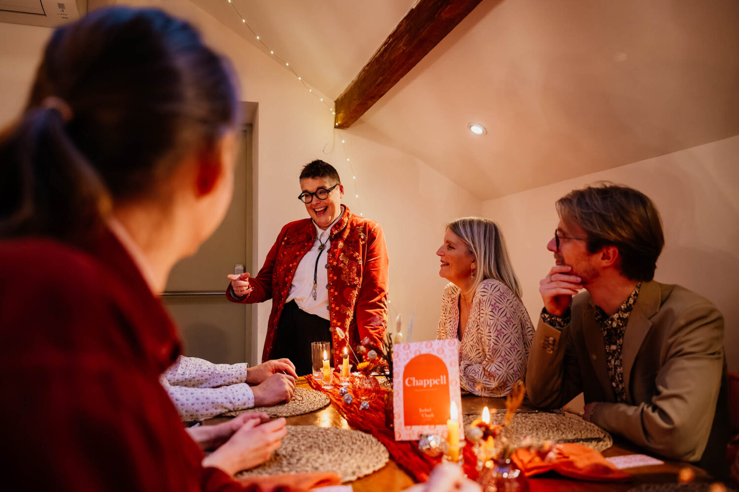 Guest chatting to table of guests during wedding reception