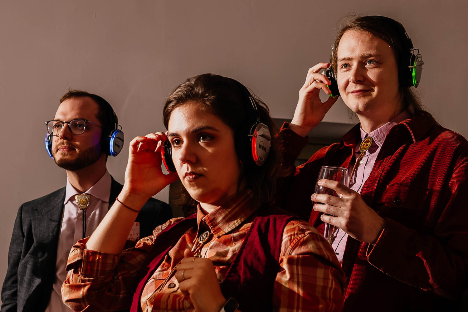 Three people with headphones on different channels during a headphone disco
