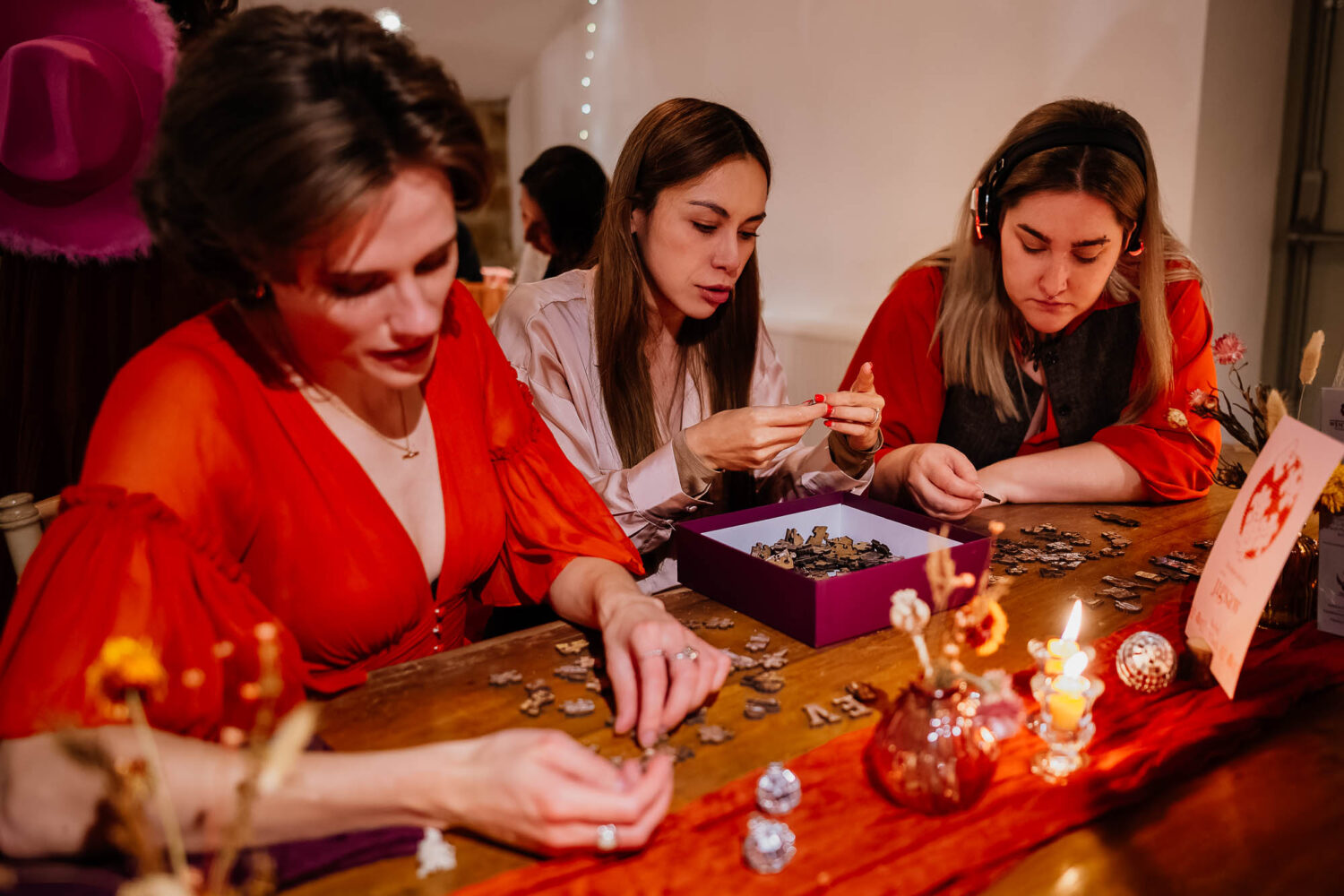 Three guests doing a jigsaw puzzle