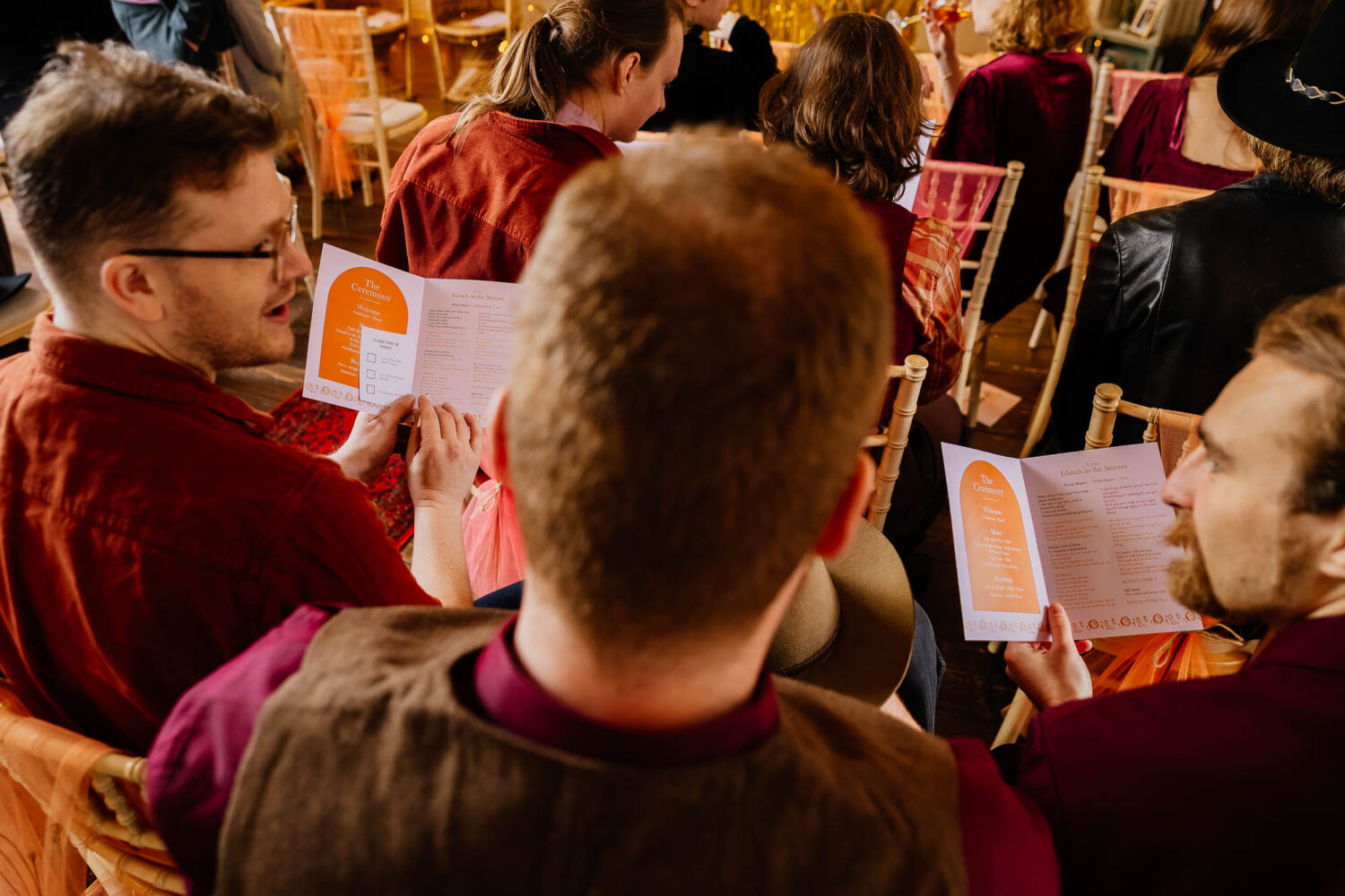 Guests holding order of service