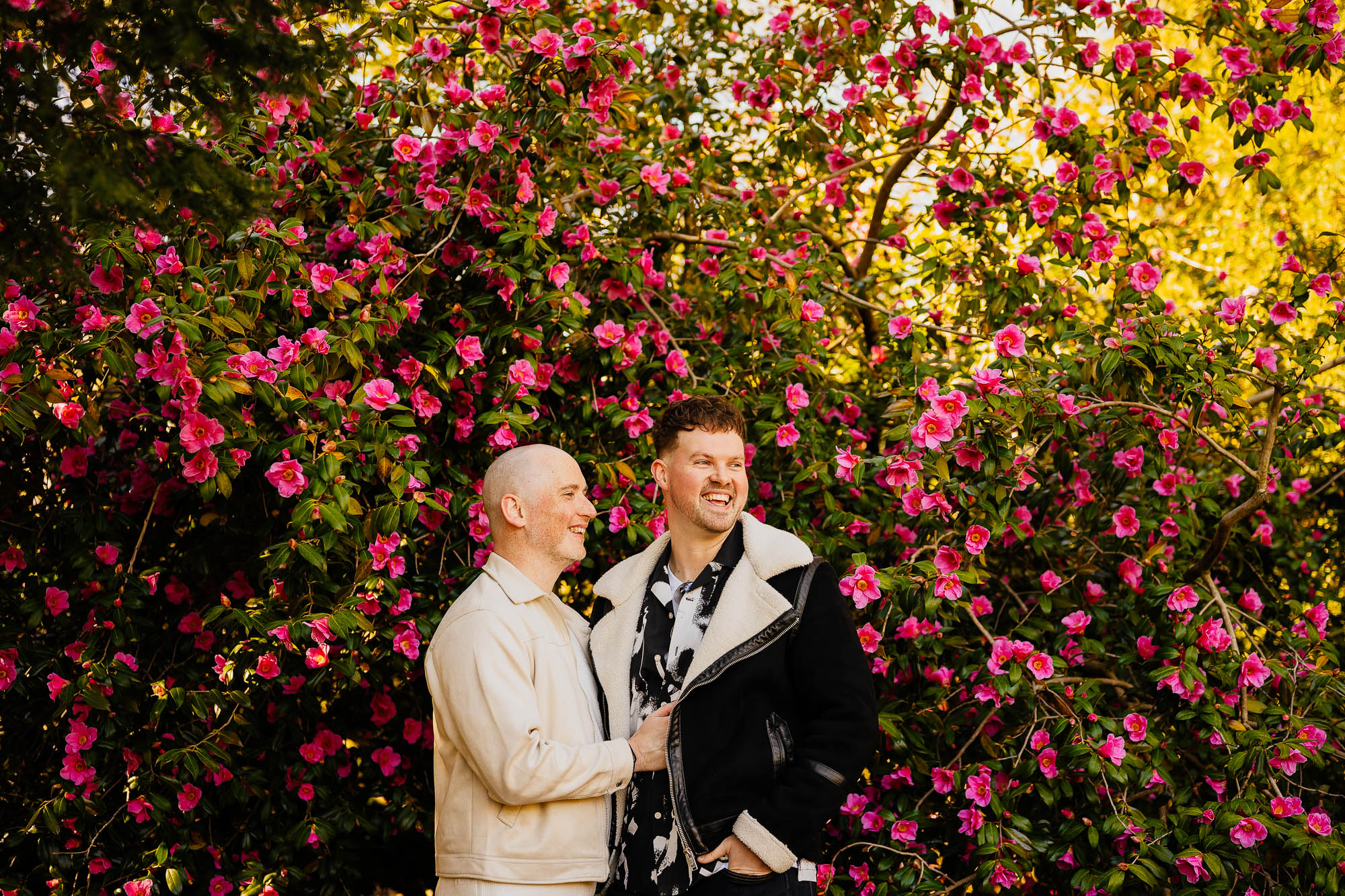 Couple laughing in pink flowers