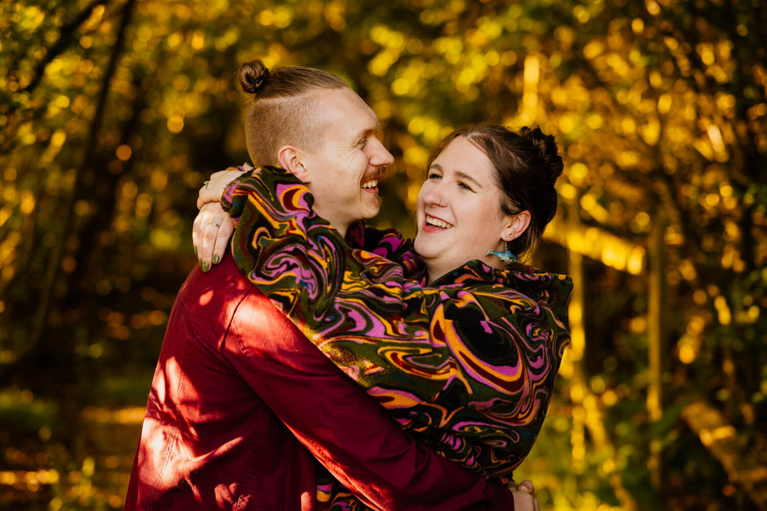 Couple hugging in woodland on pre-wedding shoot