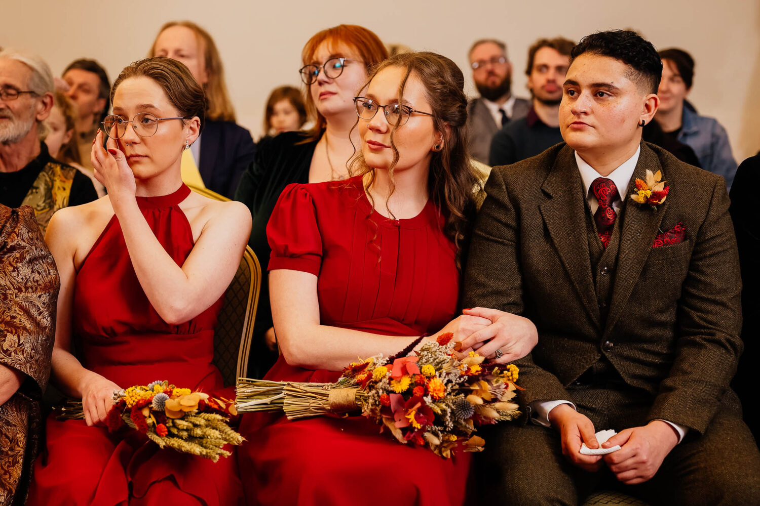 Wedding guests watching ceremony with emotion