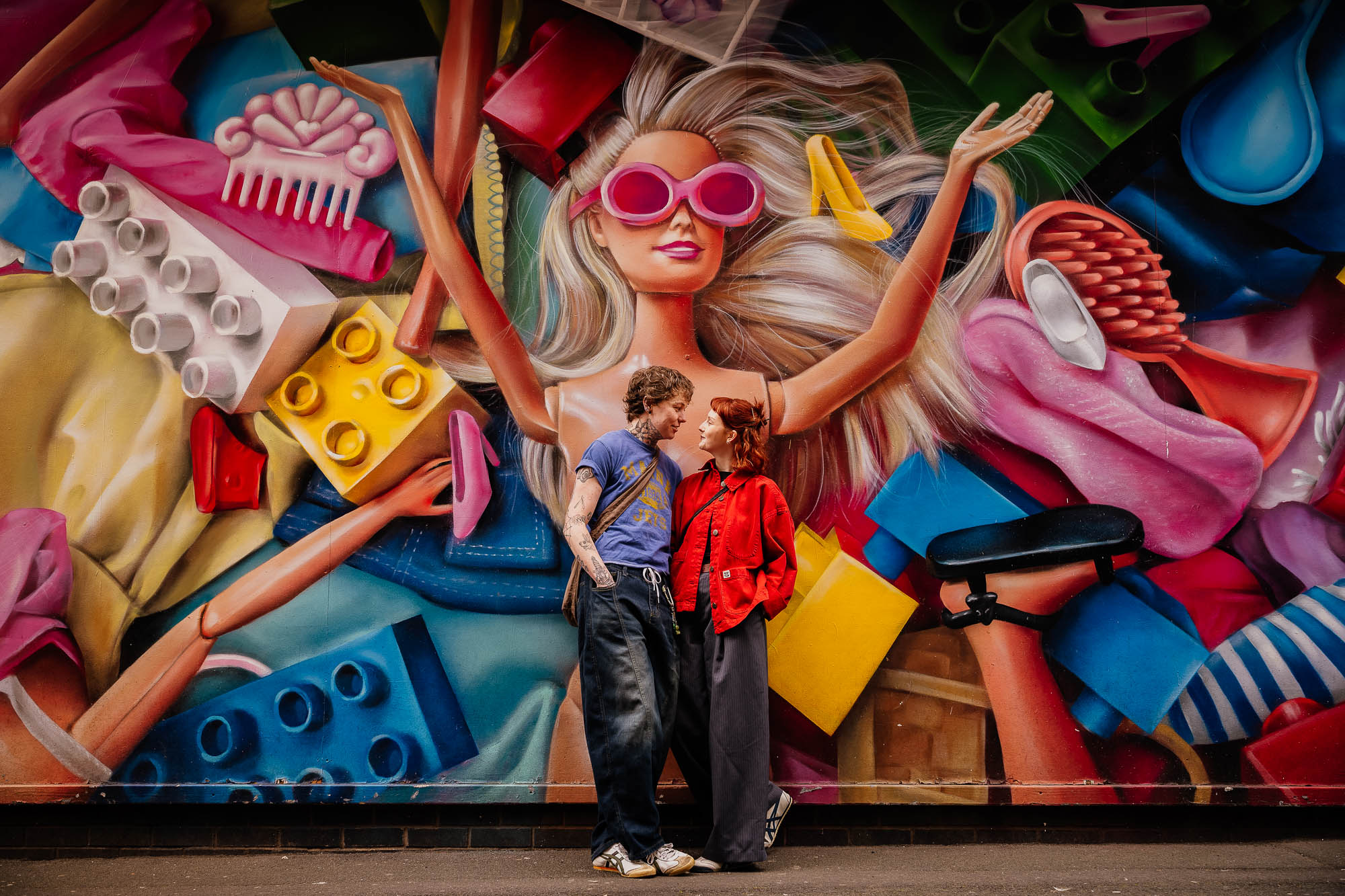 Couple portrait in front of Barbie mural