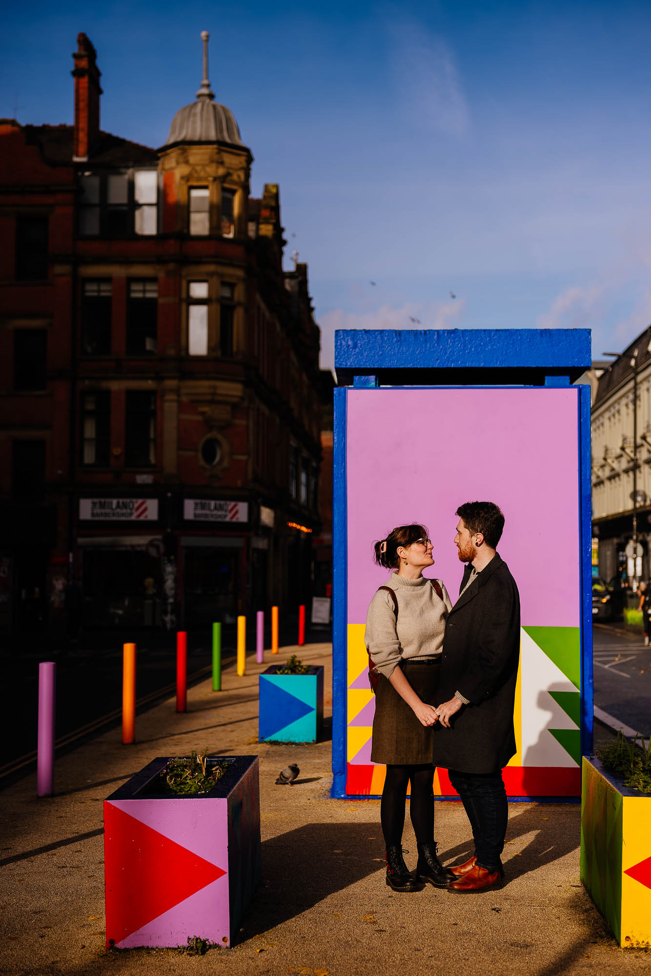 Couple in front of colourful artwork on Stevenson Square