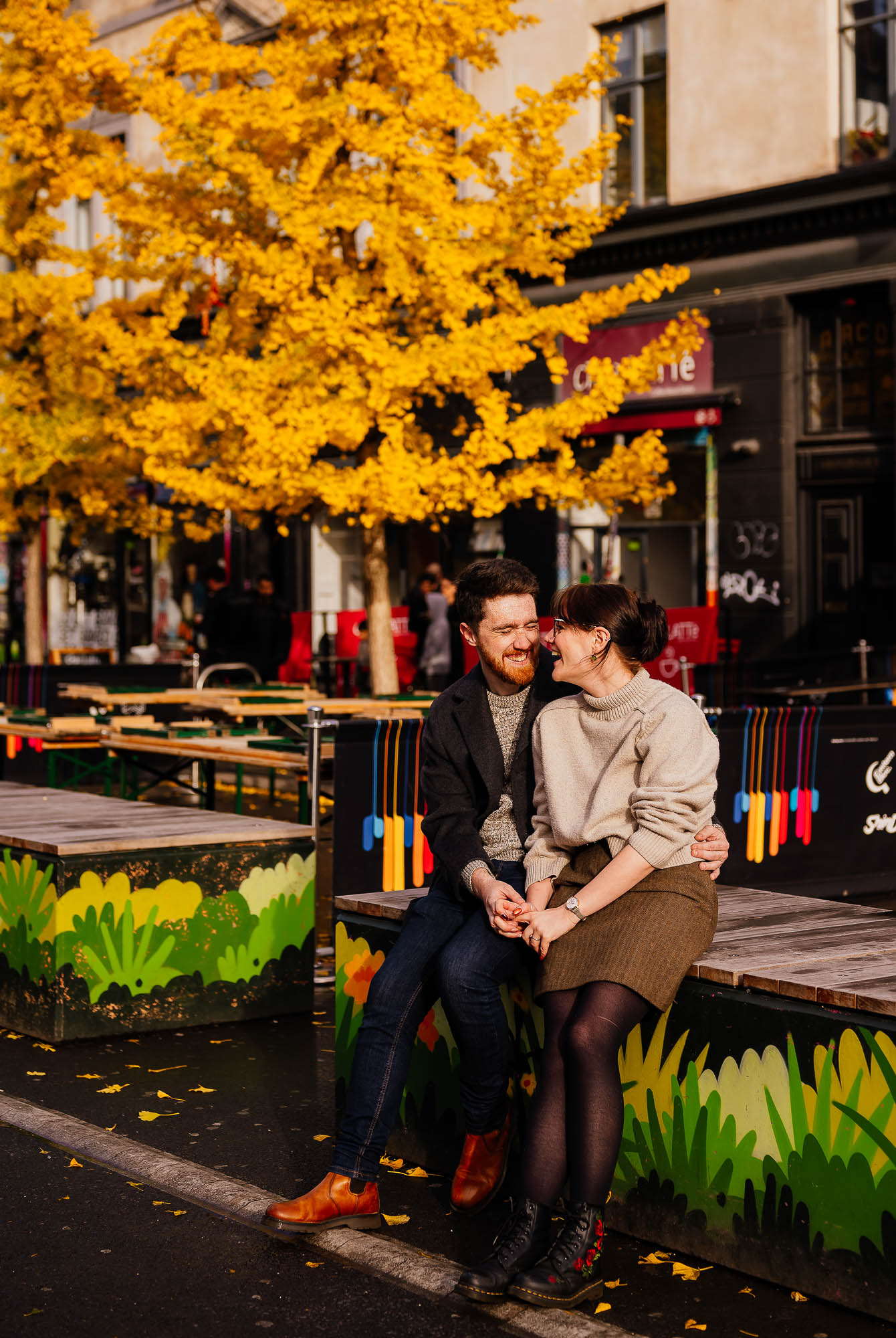 Couple sat in front of cafes on Stevenson Square in the Northern Quarter
