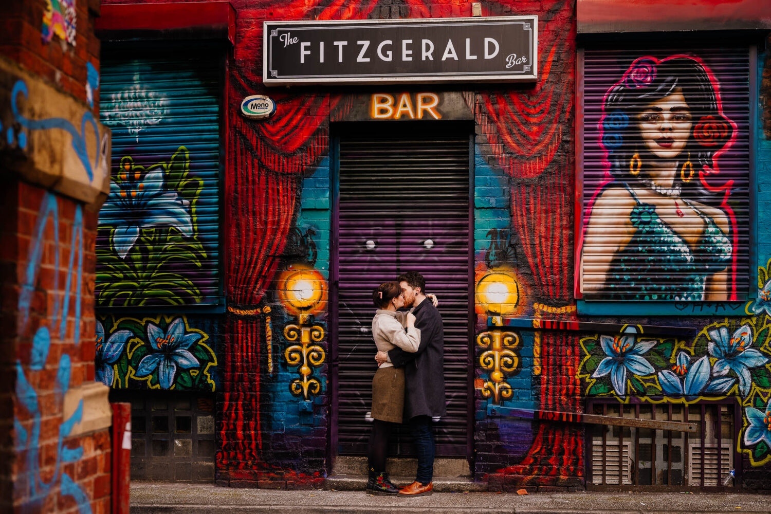 Couple kissing in front of Fitzgerald Bar off Stevenson Square