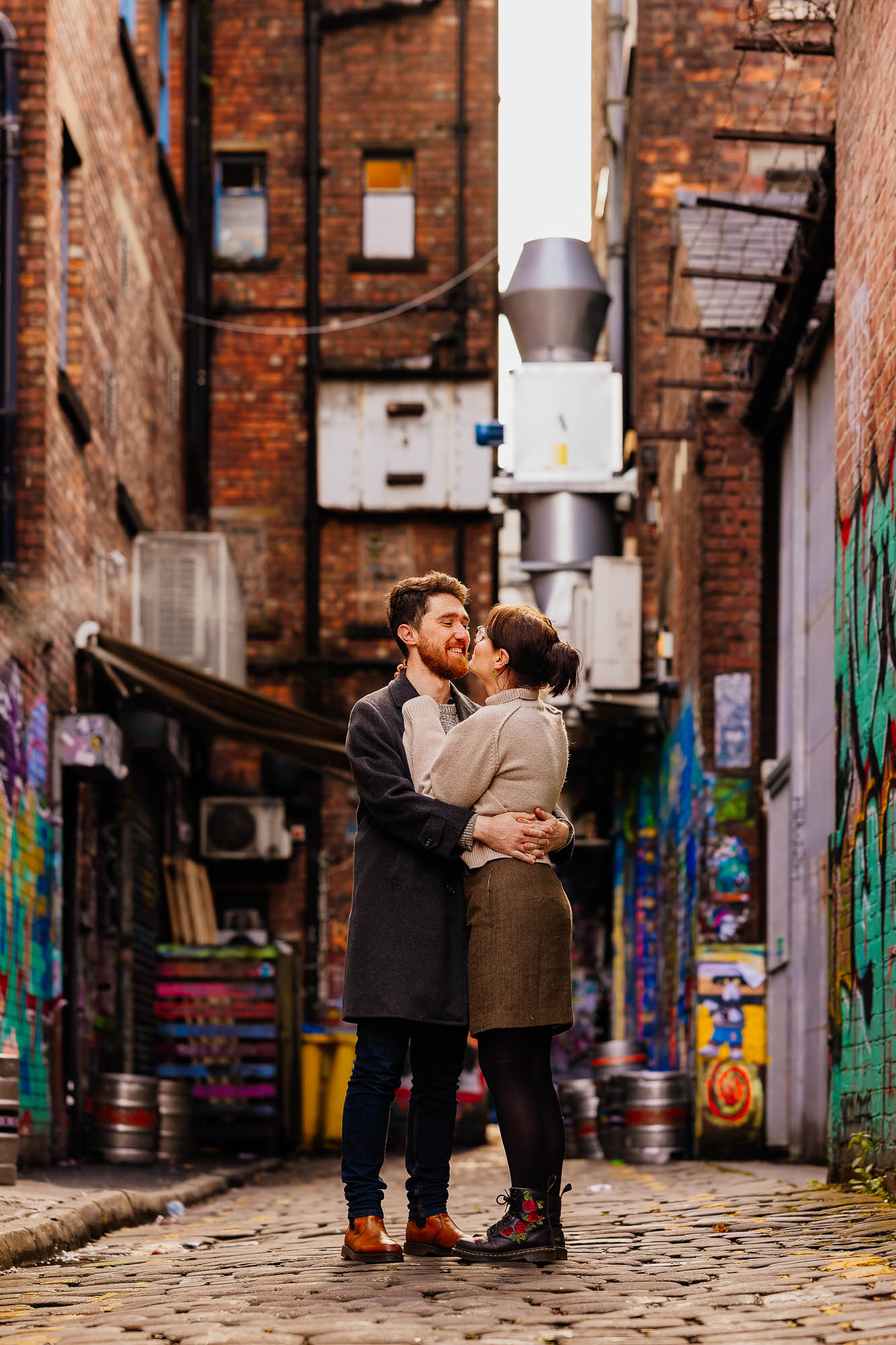Couple hugging down side street in Manchester