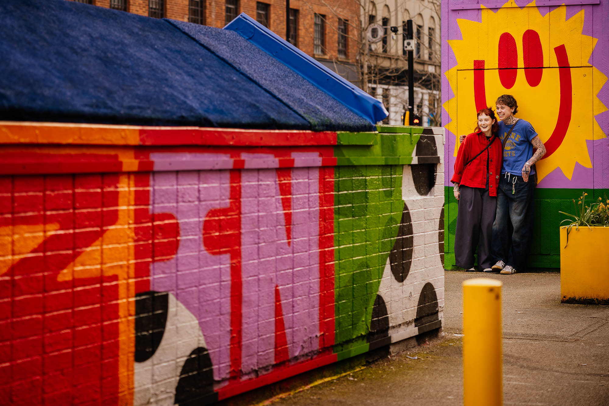 Couple portraits on Stevenson Square with Fred Aldous mural
